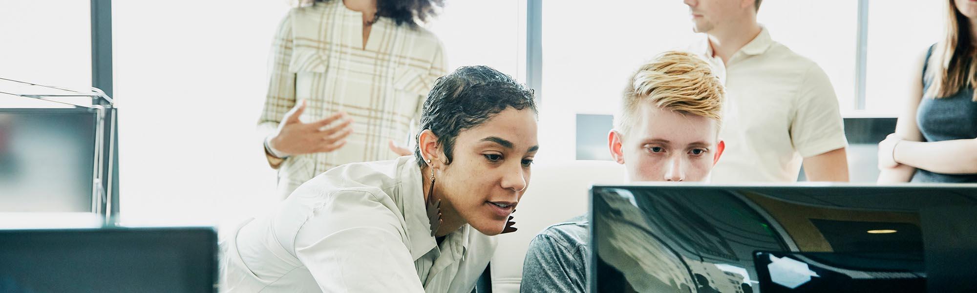 Two colleagues looking at a computer